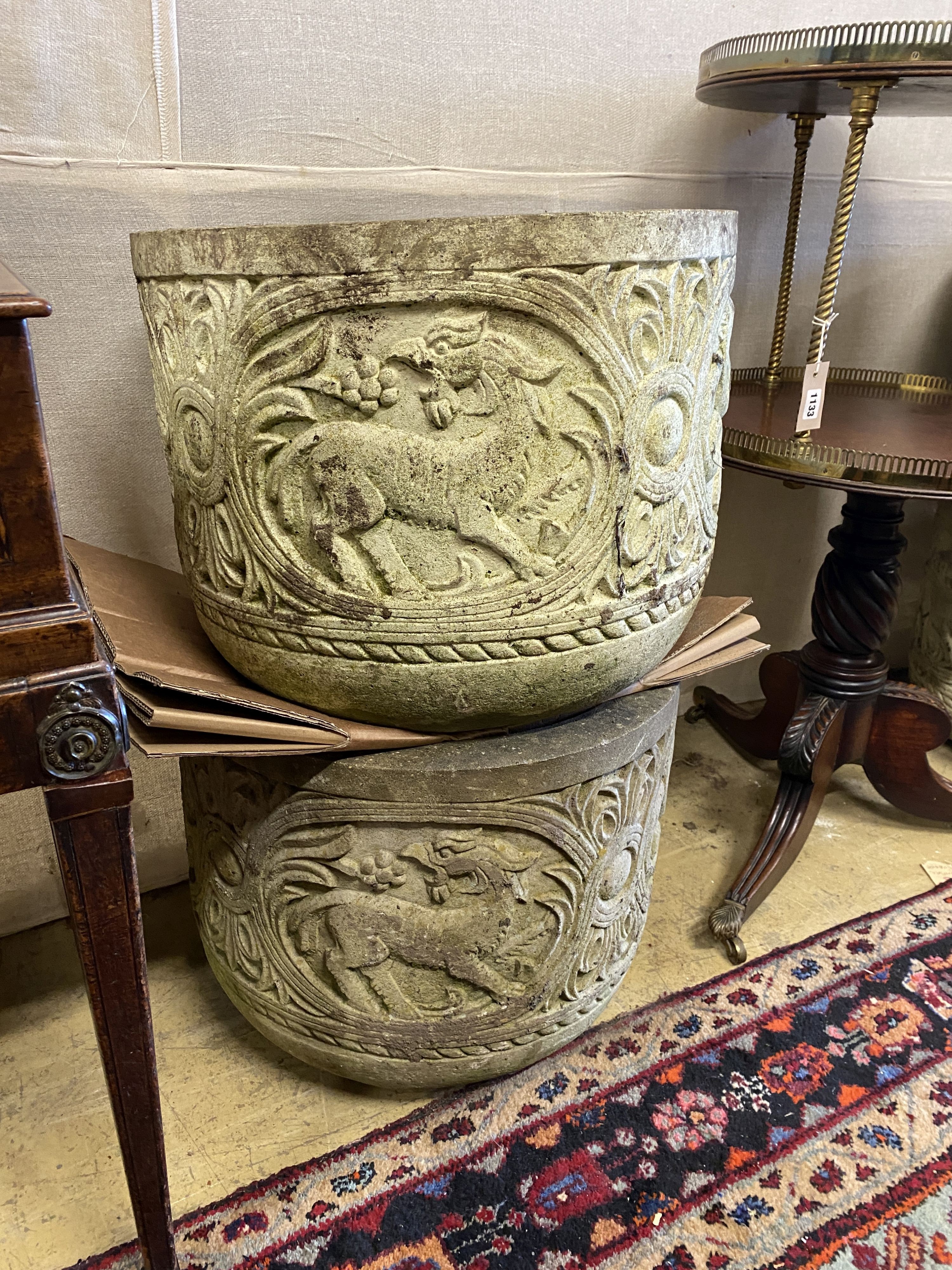 A pair of reconstituted stone circular garden planters, diameter 54cm, height 42cm